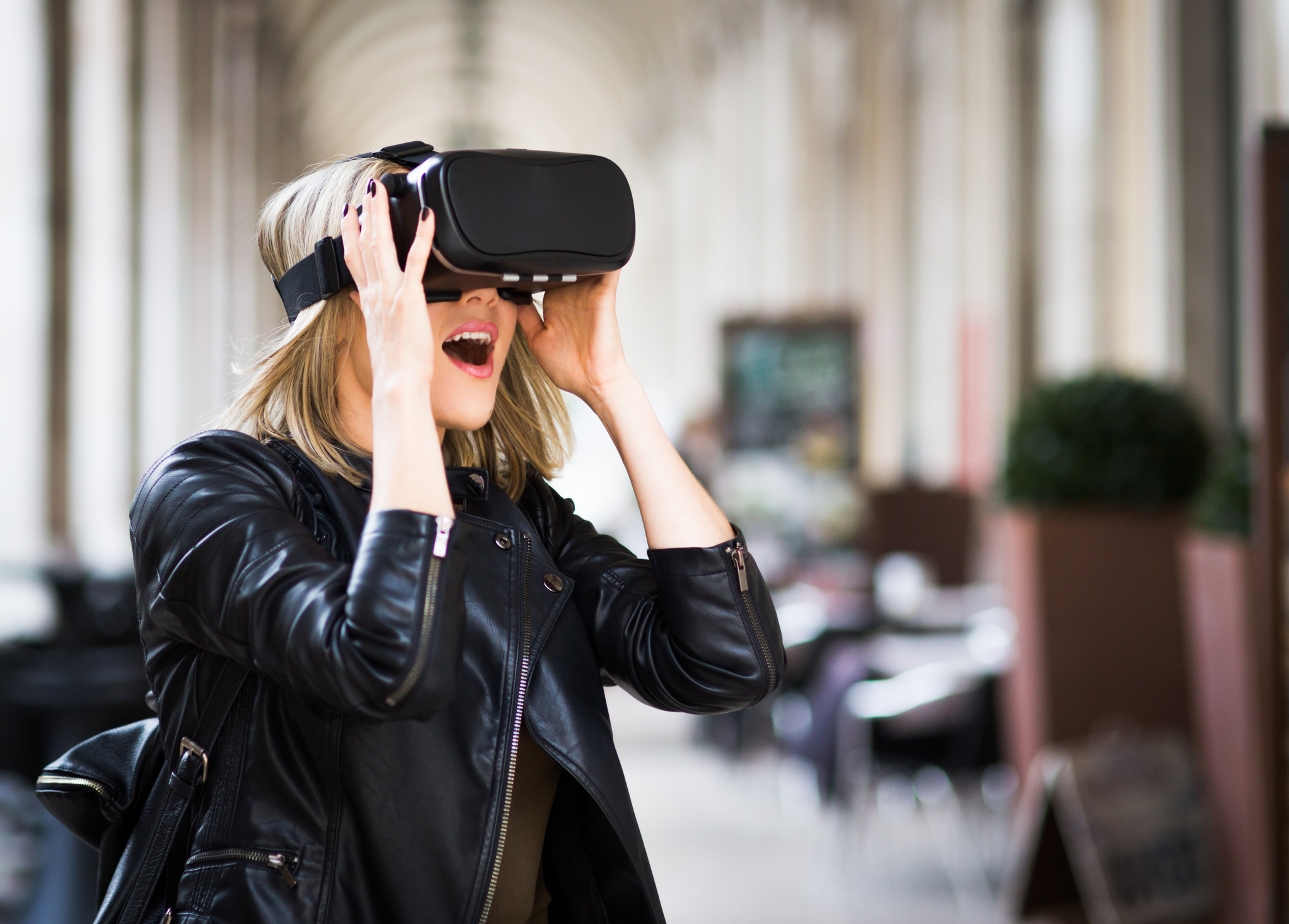 Image: iStock - Women testing Virtual Reality simulator on the street